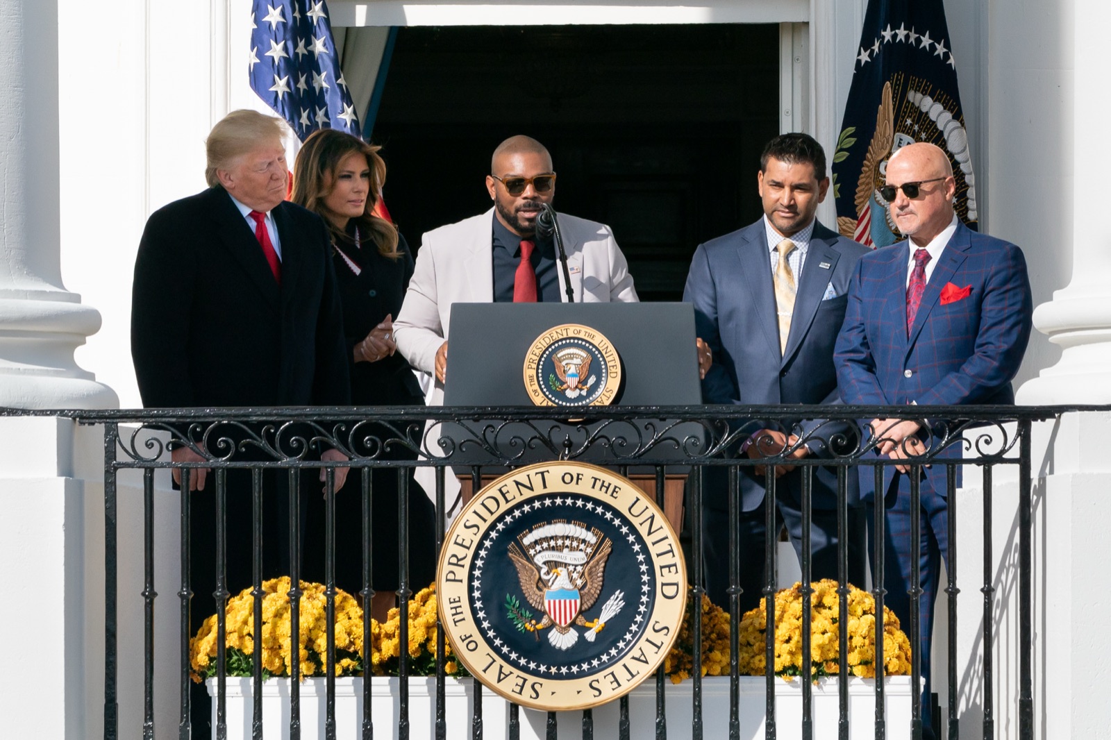 President Trump speaking from a podium with American flags